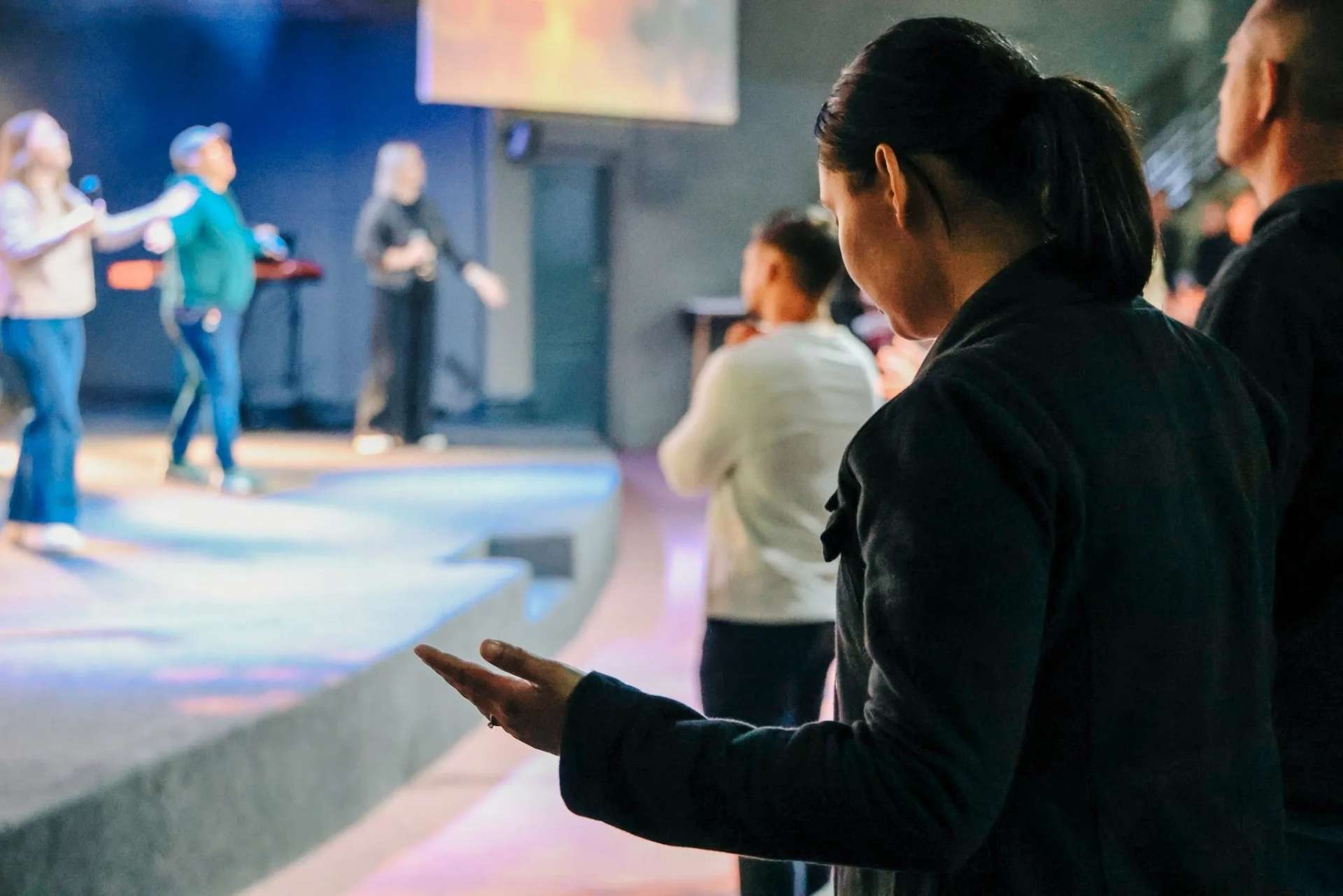 Worshippers praying during a live worship service at Christ Gen Church, a welcoming church in Cape Town for Christian community and faith