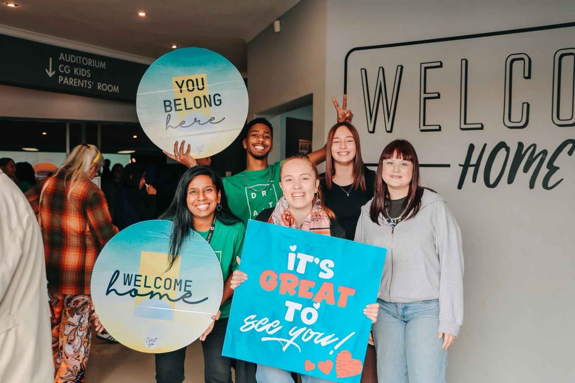 Young adults and volunteers welcoming visitors at Christ Gen Church, a family-focused church in Cape Town near Parow