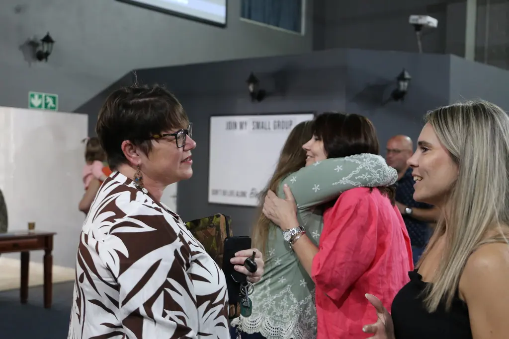 People connecting and greeting one another at Christ Gen Church Strand, one of the welcoming churches in Strand Western Cape